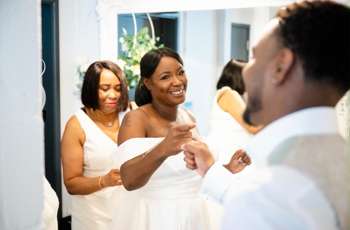A bride smiling as her jewellery is presented on her wedding morning